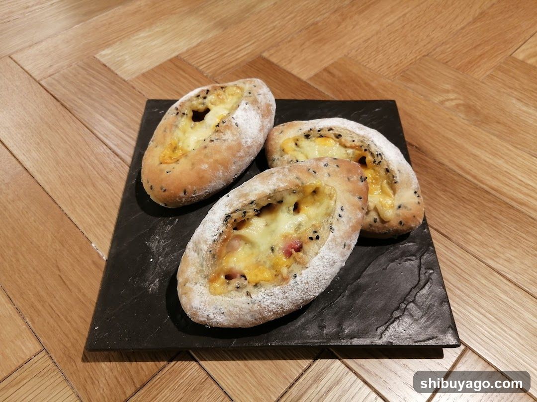 Cheese-filled bread pastries on slate board
