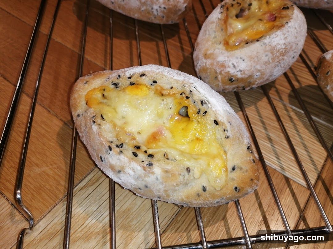Cheese and Sesame Seed Baked Pies on Cooling Rack