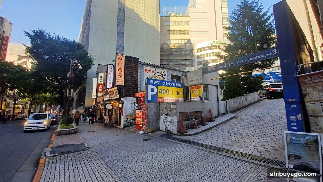 Urban street scene with parking entrance and storefronts