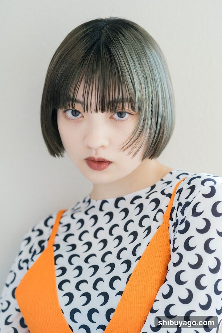 Portrait of a person with short hair and patterned clothing