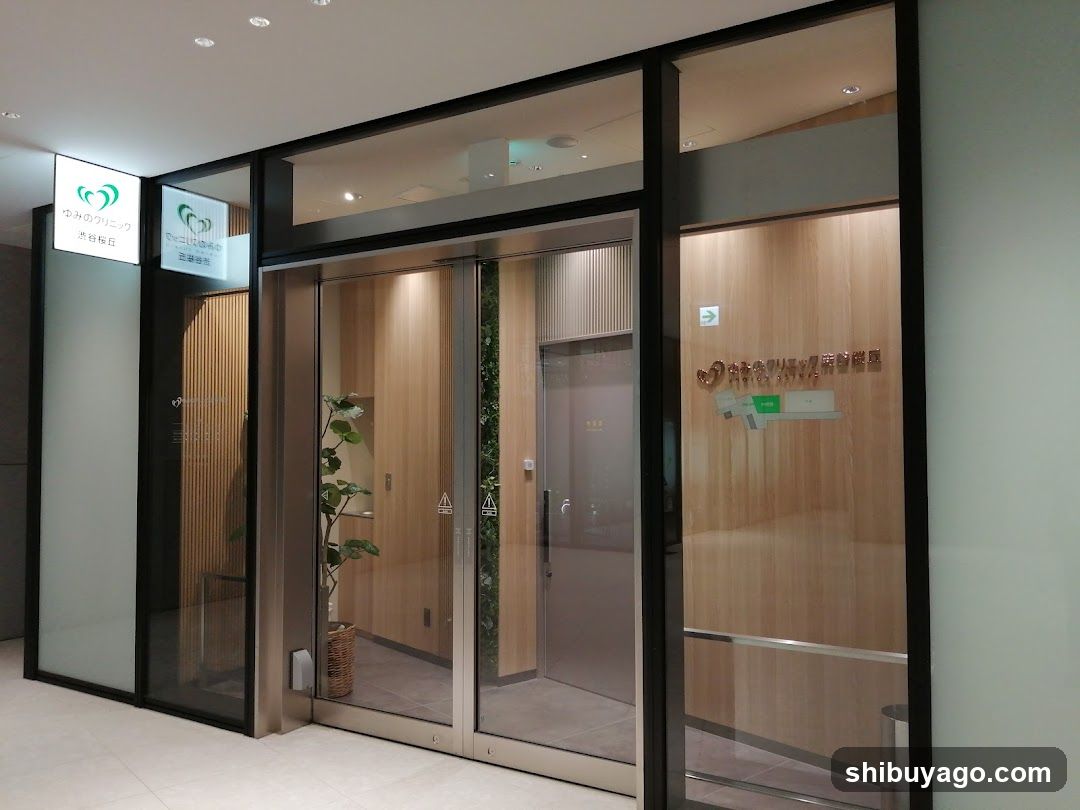 Entrance of a modern building with glass doors and wooden paneling