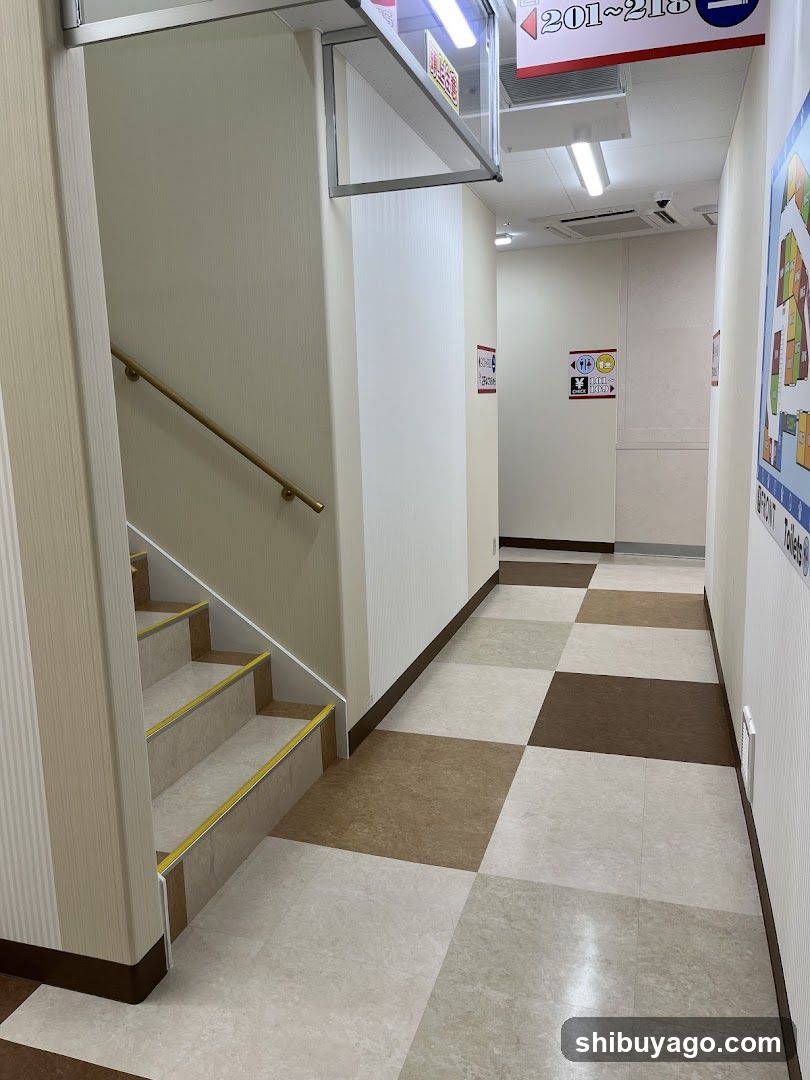 Interior hallway with stairs and signage