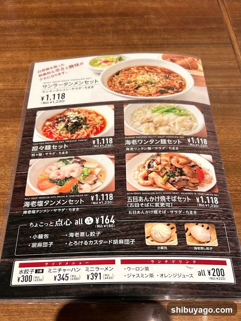 A printed menu featuring various noodle dishes with prices in yen, including Sanran Danmen Set, Yaki Tofu Noodles, Seafood Wonton Noodles, and others.