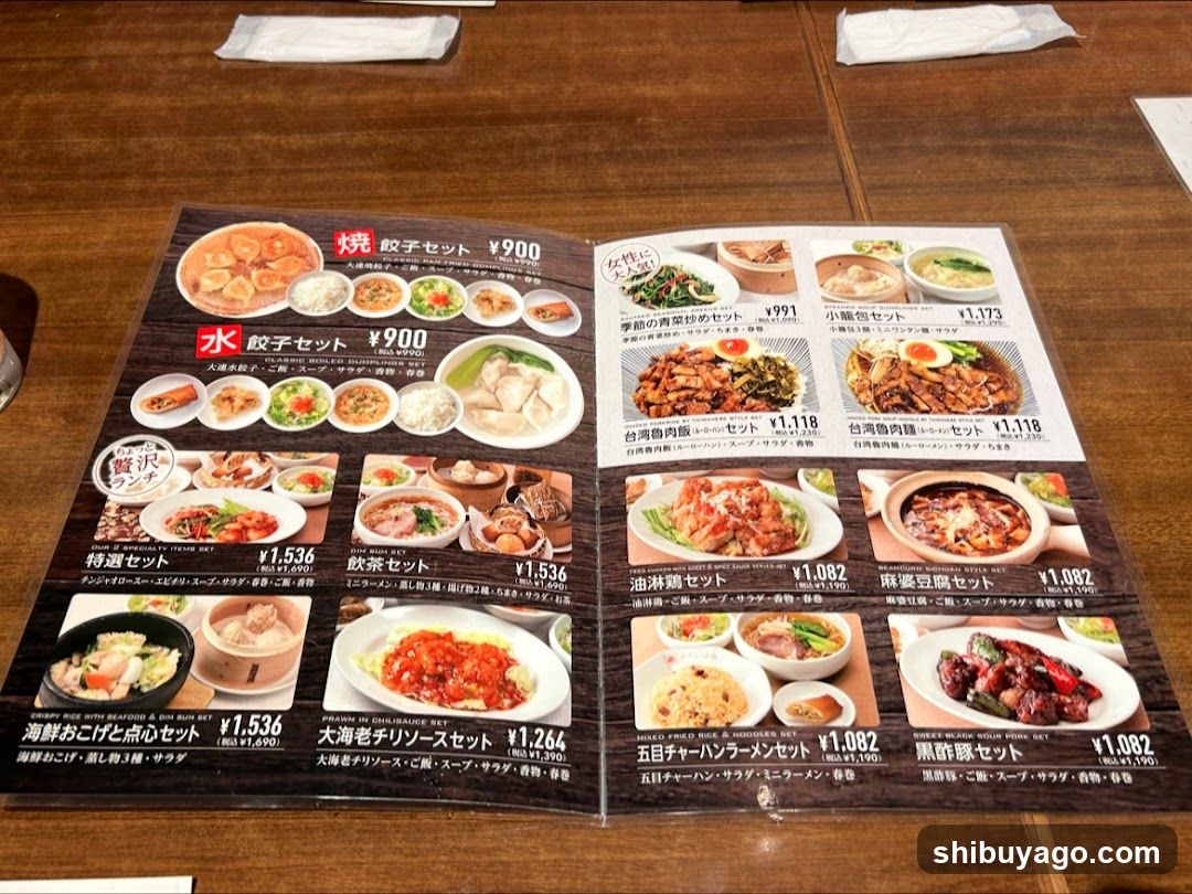 A printed menu spread open on a wooden table, featuring various set meals with photos and prices in Japanese yen.