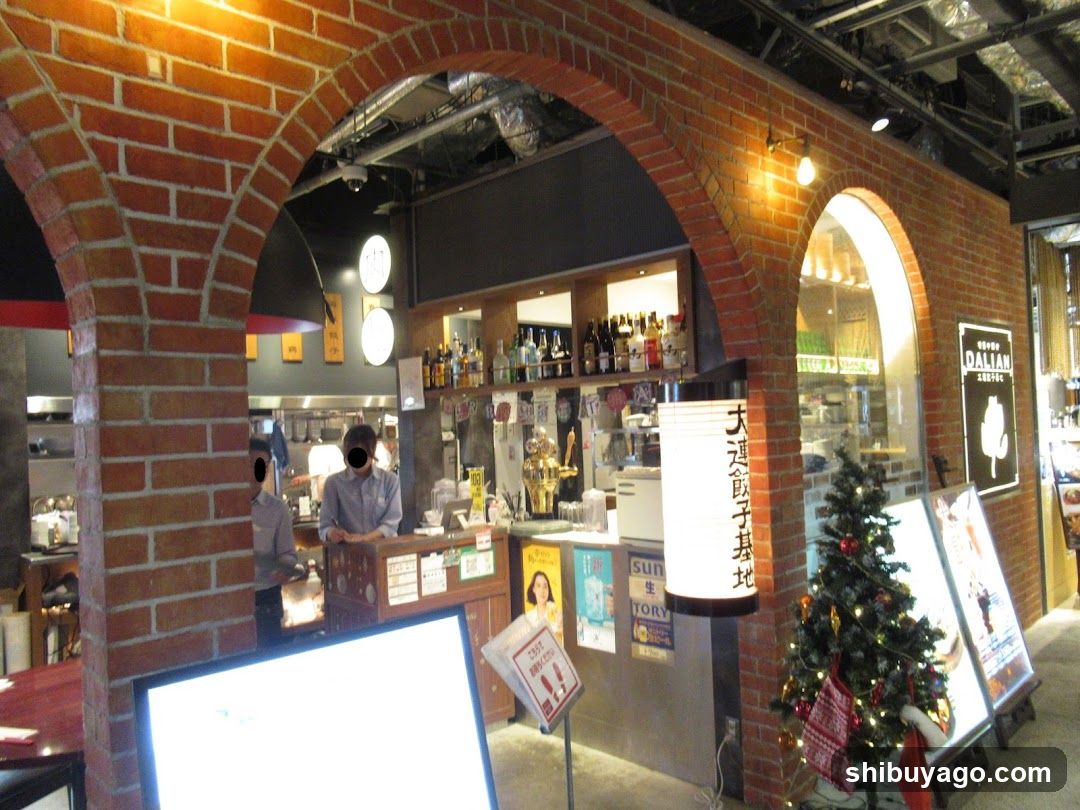 Interior of a restaurant or cafe with brick arches and staff at the counter.