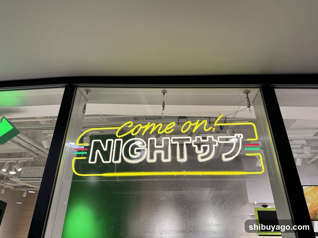 A storefront window displays a neon-style sign with the text 'Come on! NIGHT サブ' in yellow and white lettering, framed by a yellow outline. The interior shows green lighting and ceiling fixtures.