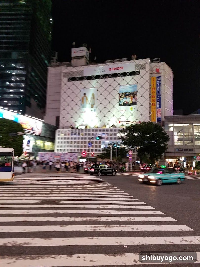 Night street scene with crosswalk and buildings