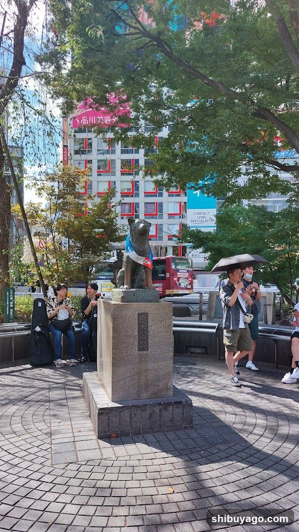 Urban Square with Statue and Pedestrians