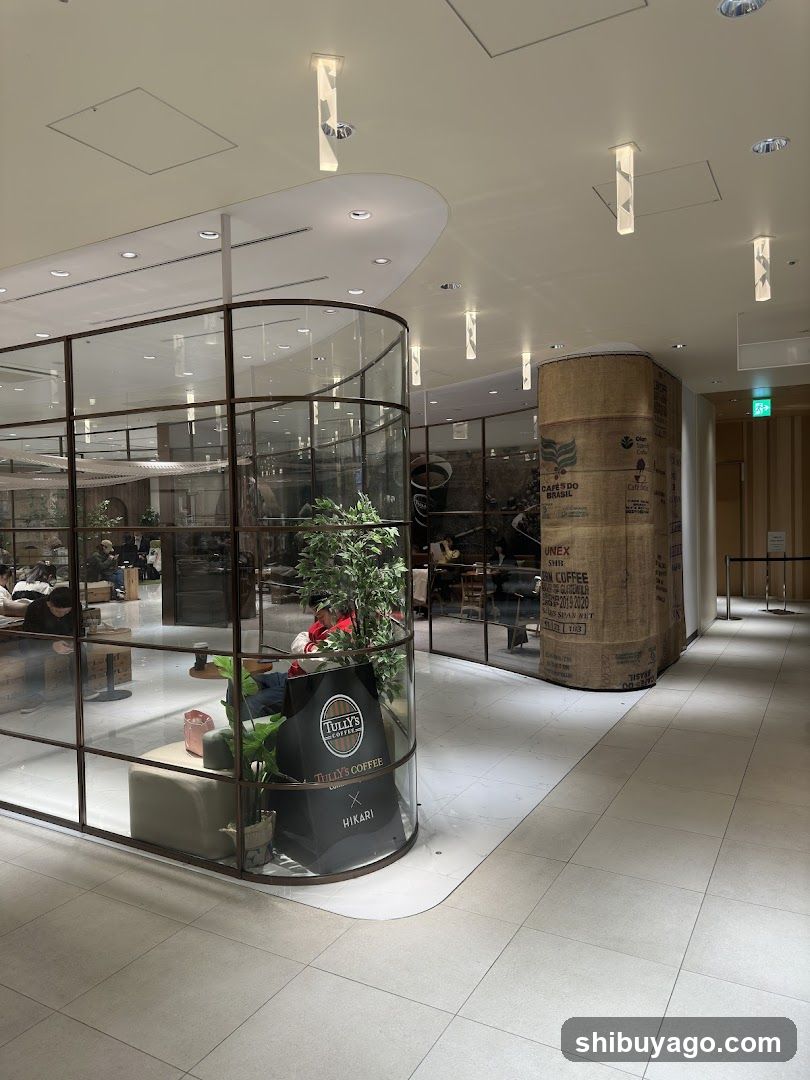 Interior of a modern coffee shop with glass enclosure and burlap-wrapped column