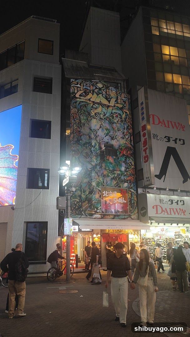 Night street scene with graffiti and storefronts