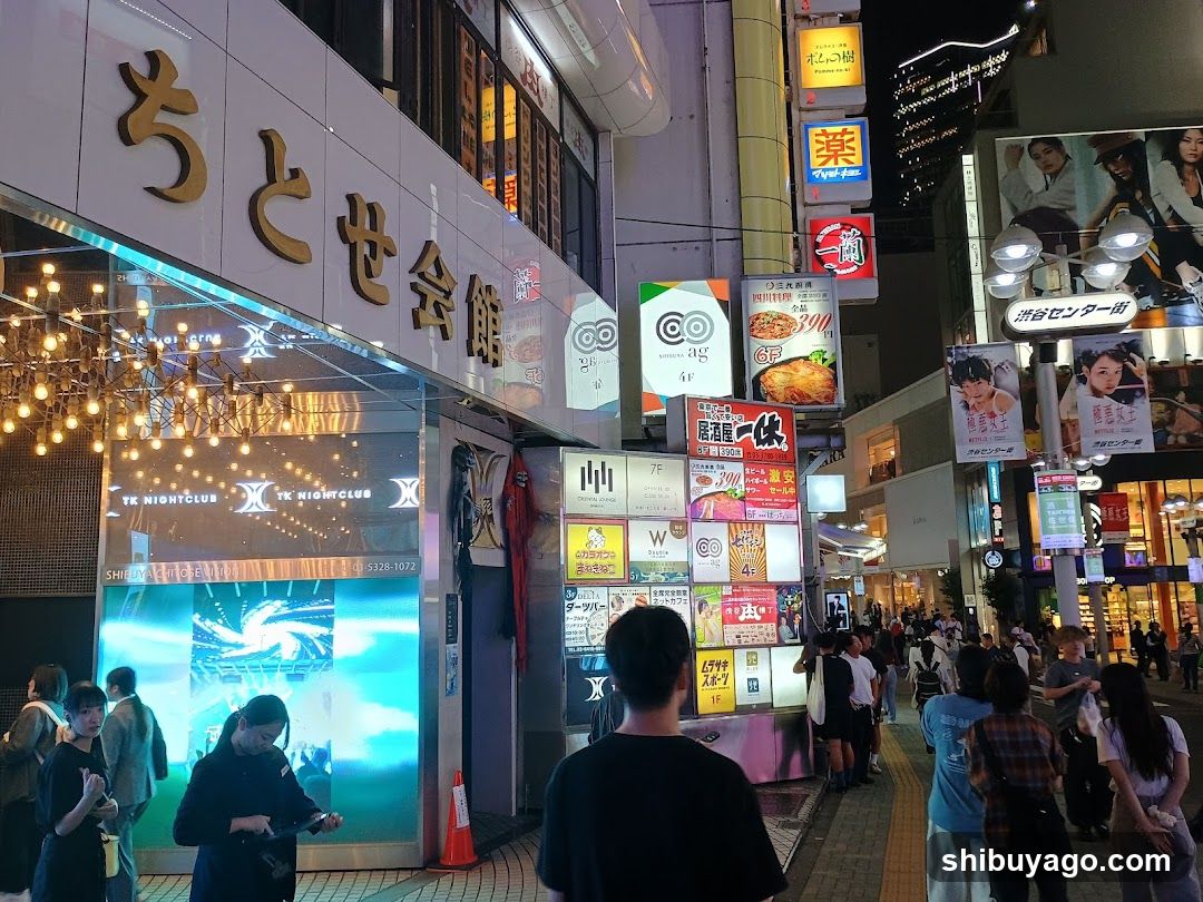 Night Street Scene with Shops and Crowds