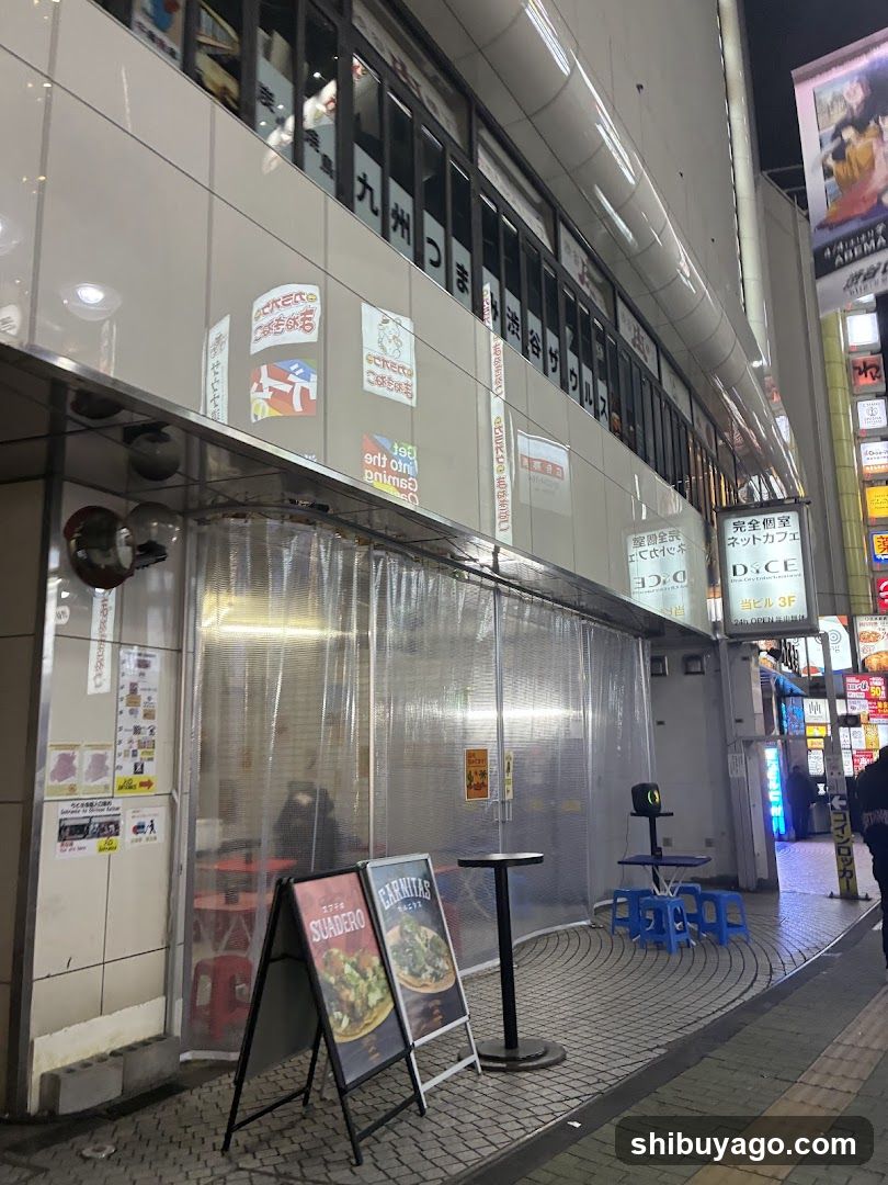 Street-side storefront with plastic curtains and signage