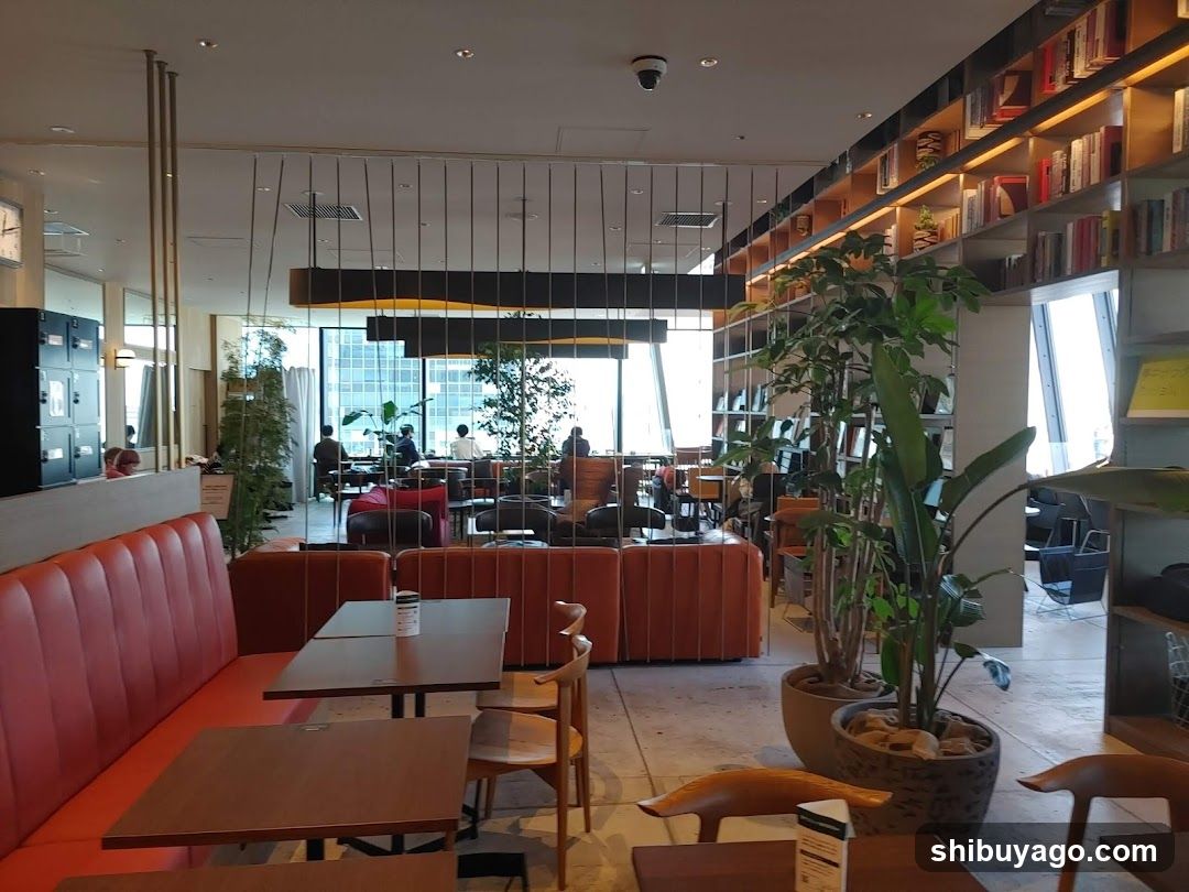 Modern Cafe Interior with Red Booths and Bookshelves
