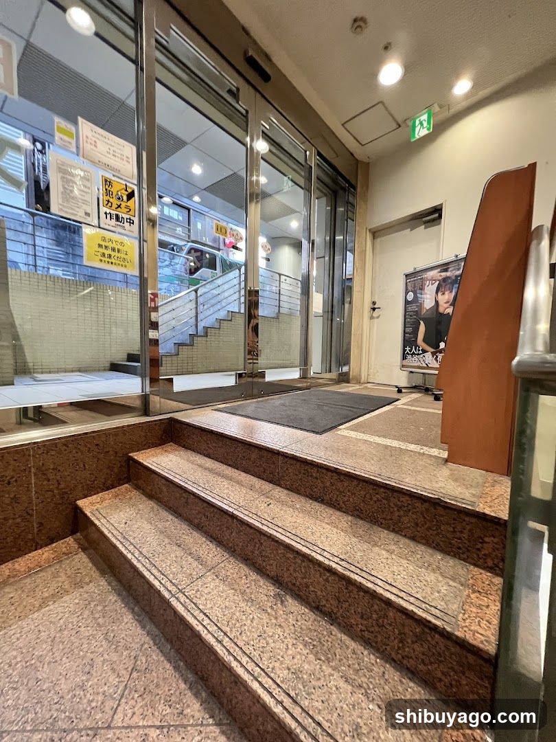 Entrance to a building with glass doors and posters
