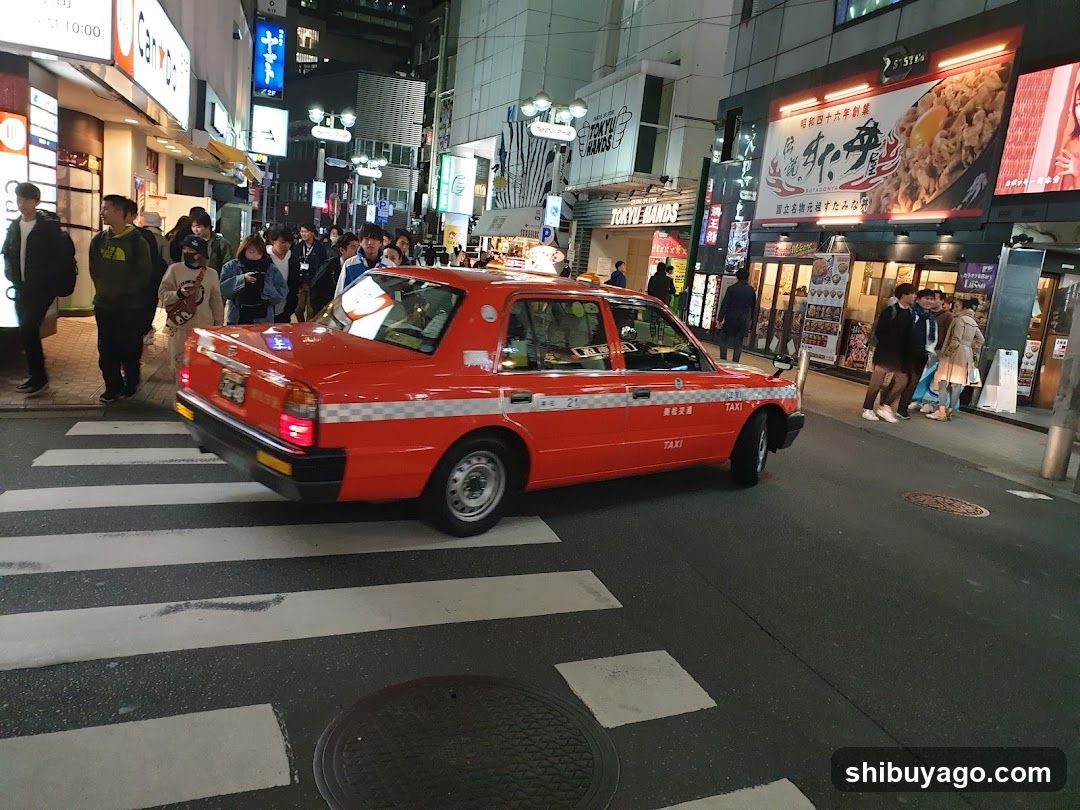 Red Taxi in a Busy Street at Night