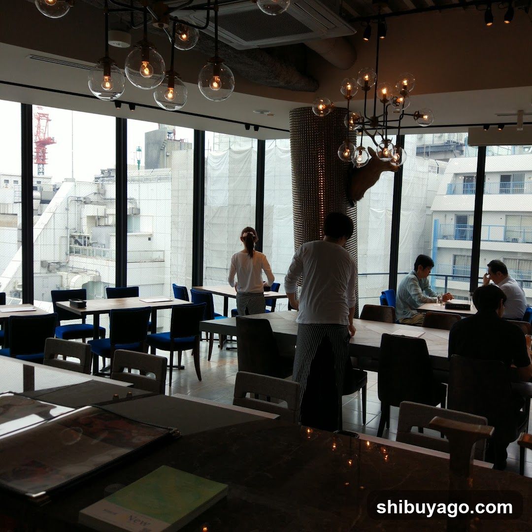 Restaurant Interior with Large Windows and Staff Serving Customers