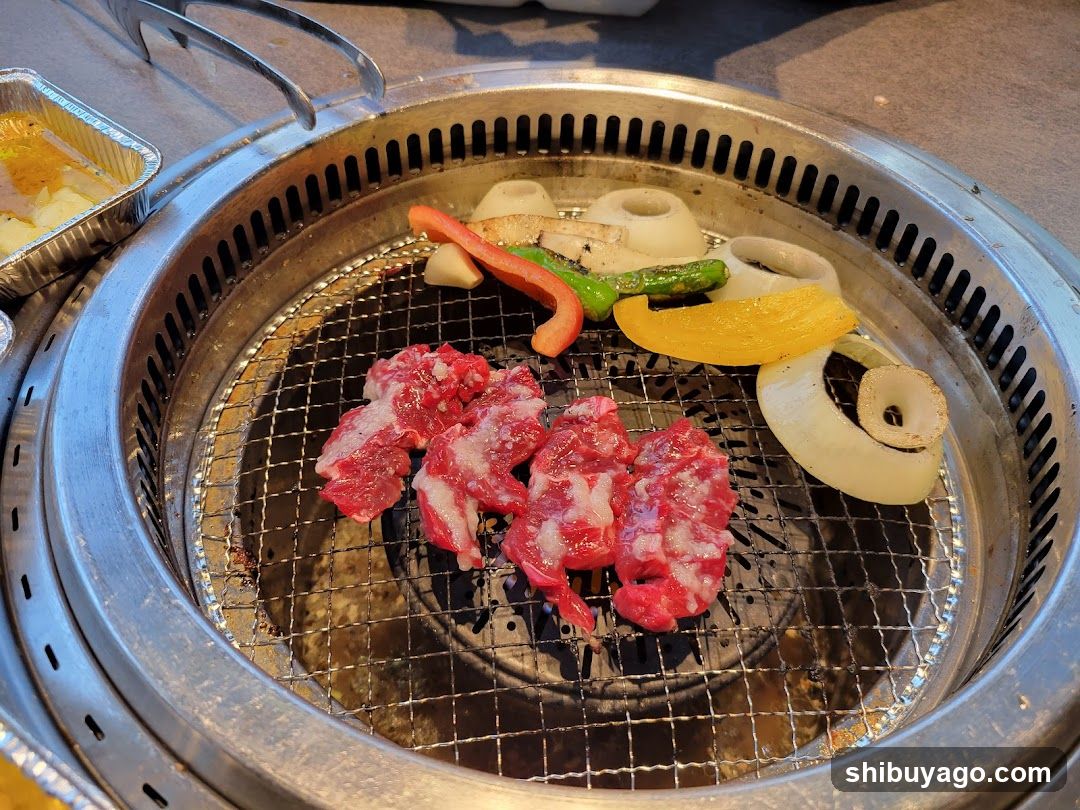 Grilled Meat and Vegetables on a Round Grill