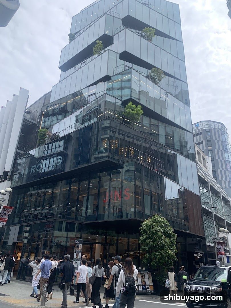 Modern Glass Building Exterior with Pedestrians