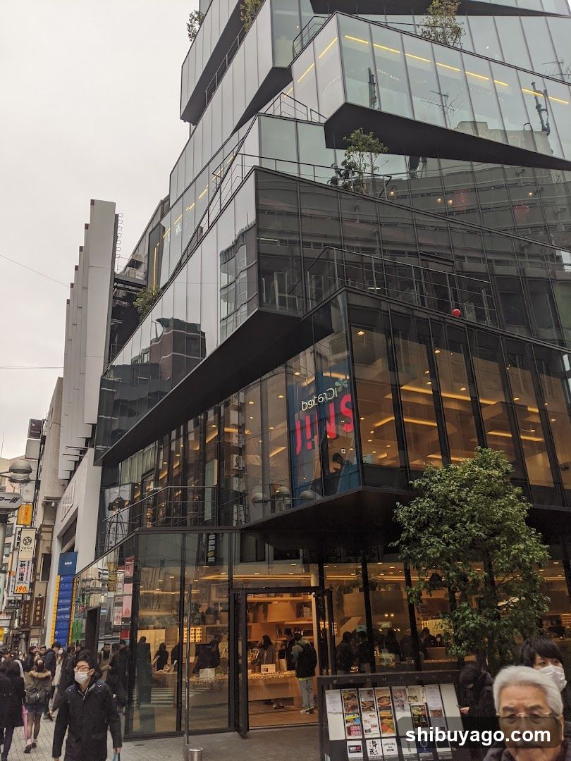 Modern Glass Building Exterior with Pedestrians
