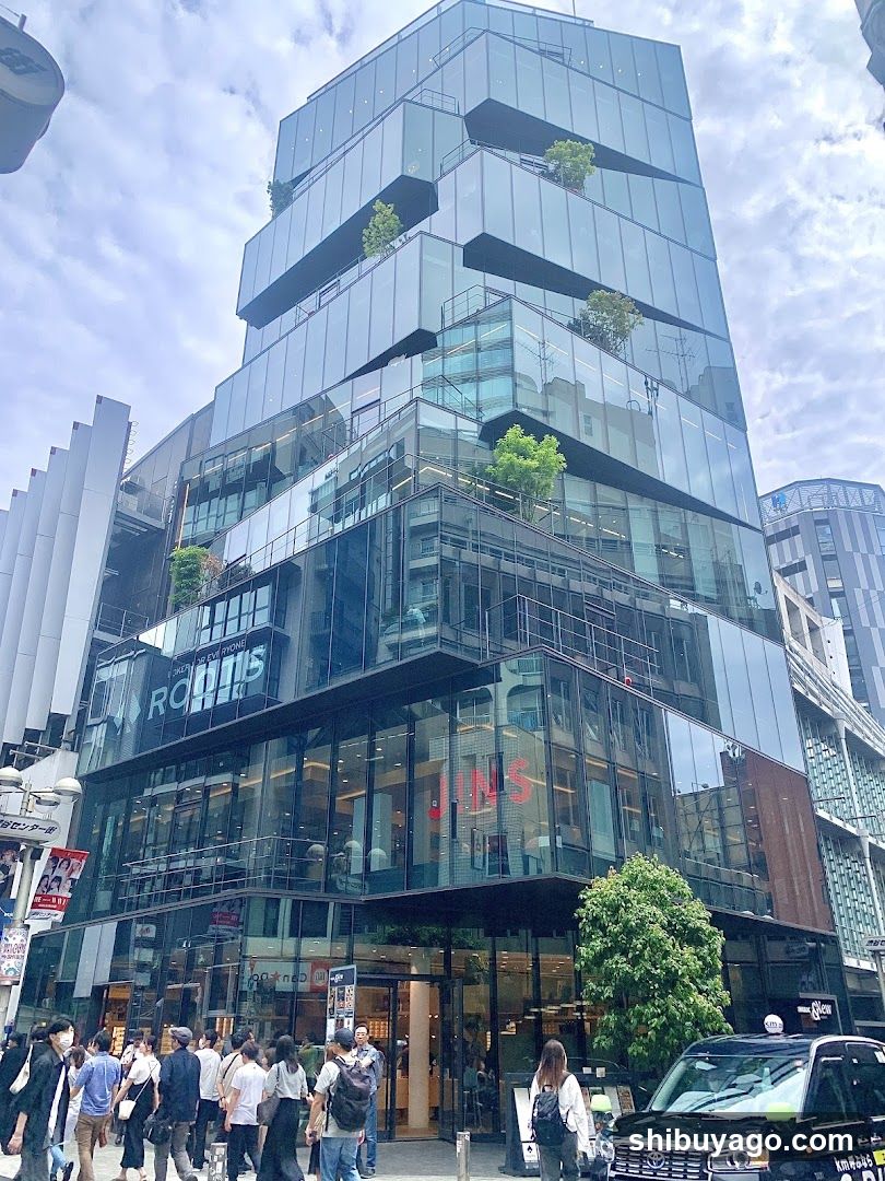 Modern Glass Building Exterior with Pedestrians