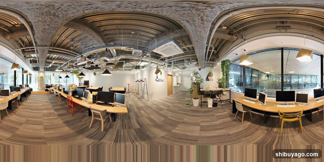 Open-plan office space with exposed ceiling and desks