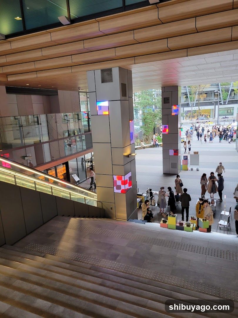 Modern Building Entrance with Stairs and People