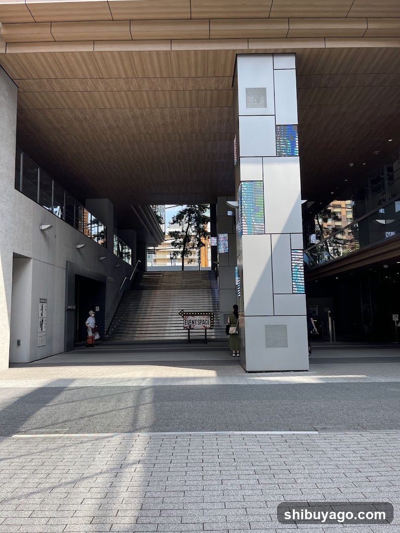 Entrance to a modern building with stairs and signage