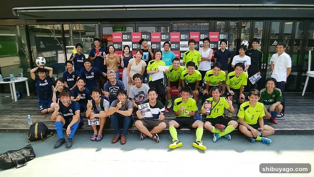 Group photo in front of building with Kirin banners