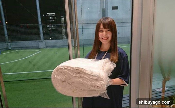 Woman holding bundled white fabric