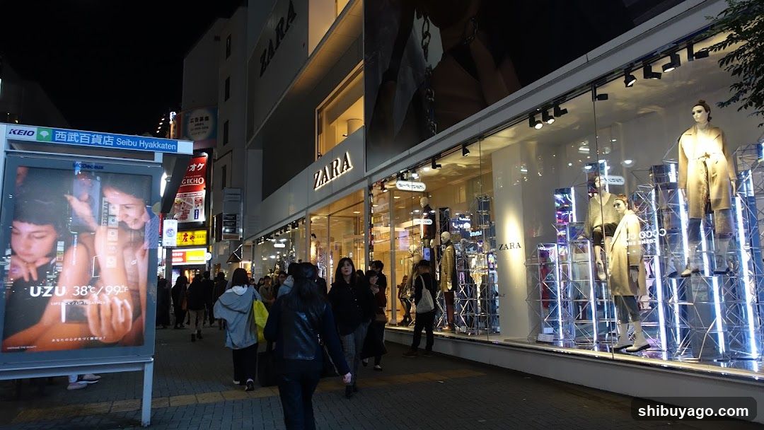 Night Street Scene with Storefronts and Pedestrians