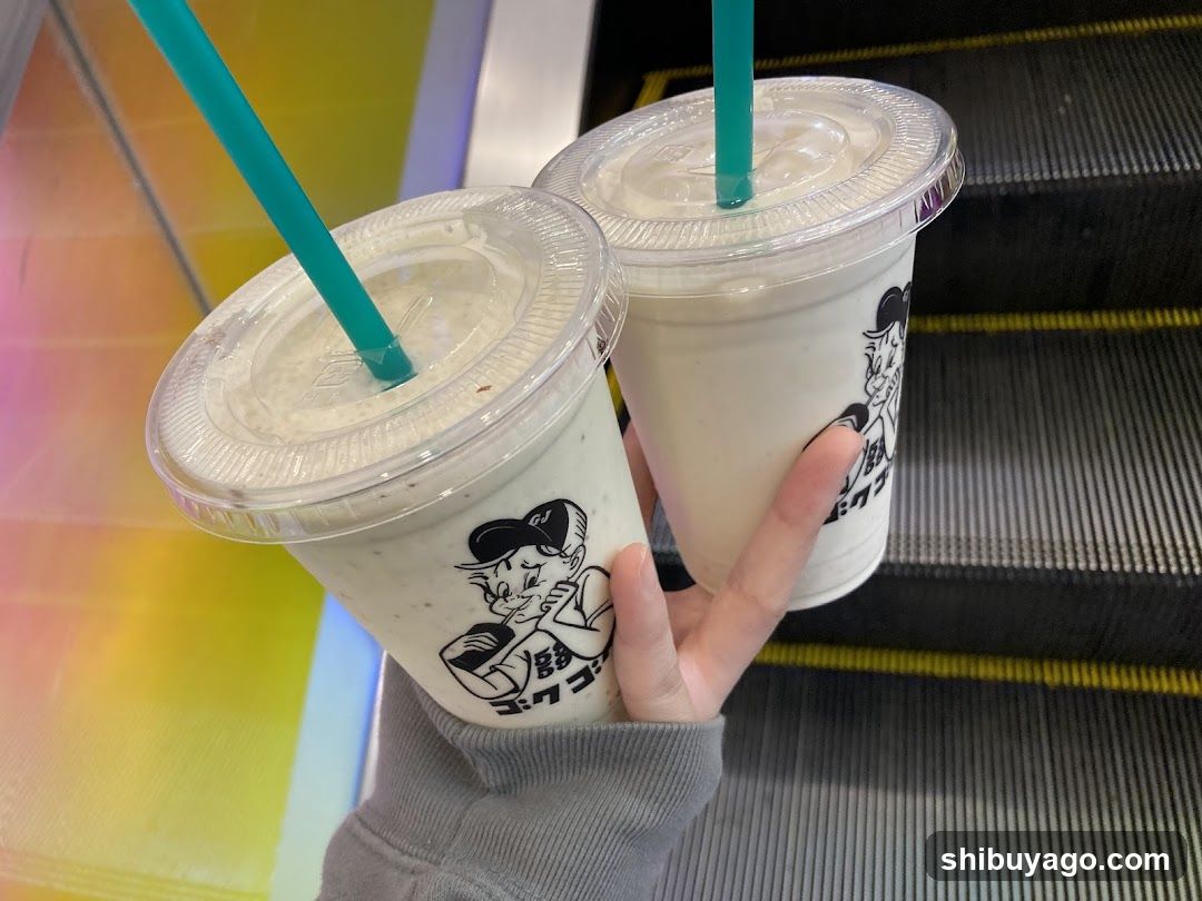 Two iced coffee drinks in branded cups