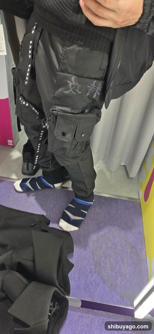 Person trying on cargo pants in store