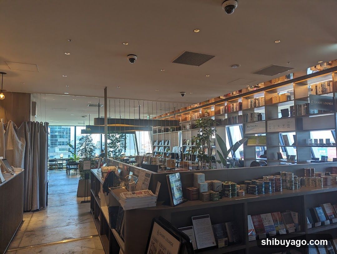 Interior of a modern bookstore or cafe with bookshelves and merchandise display