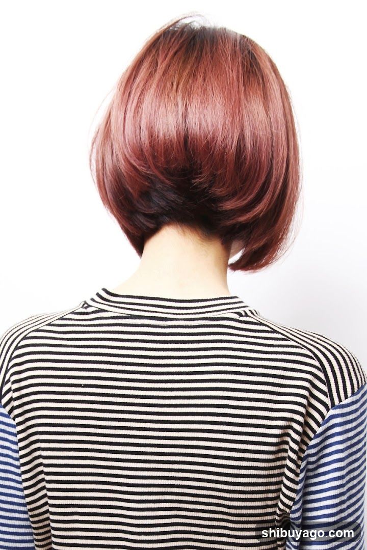Back view of person with short reddish-brown hair wearing striped shirt