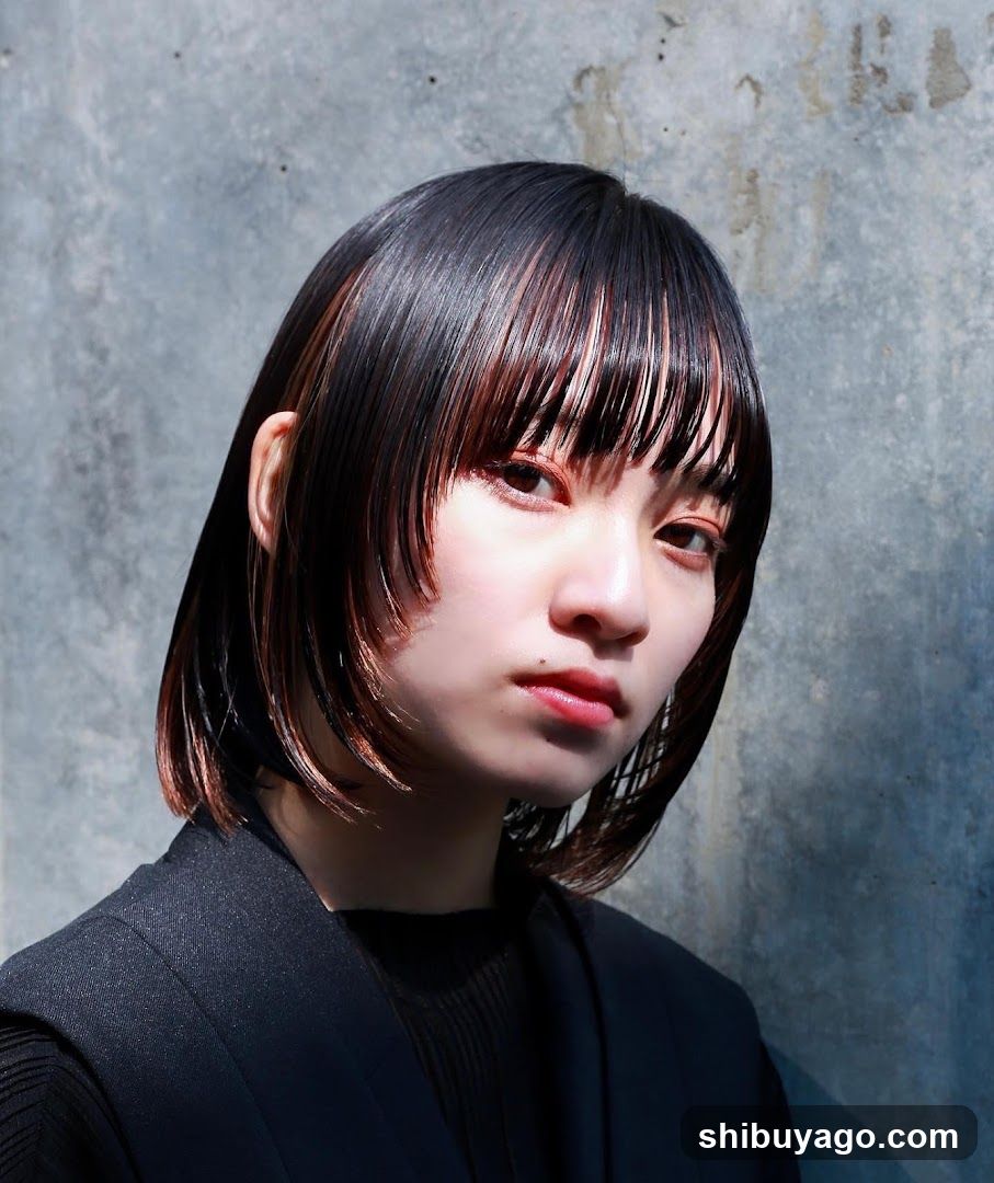Portrait of a woman with short hair against concrete wall