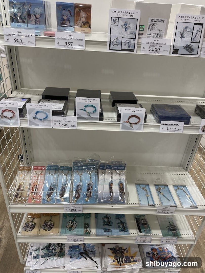 A white shelving unit in a store displays various anime merchandise, including keychains, bracelets, and figures with price tags ranging from ¥957 to ¥5,500.