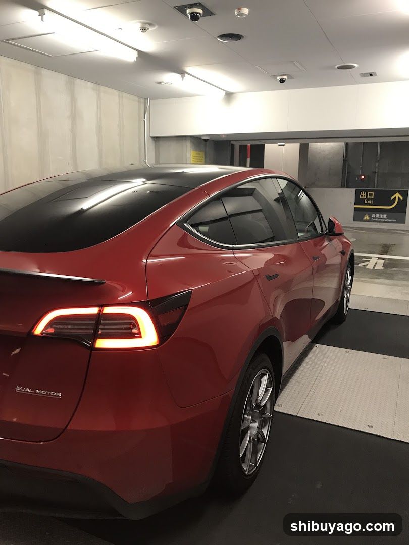 Red Tesla Model Y in Parking Garage