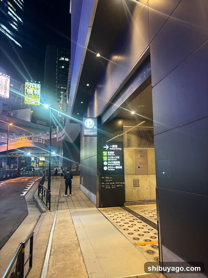 Night street scene with illuminated signs and building entrance