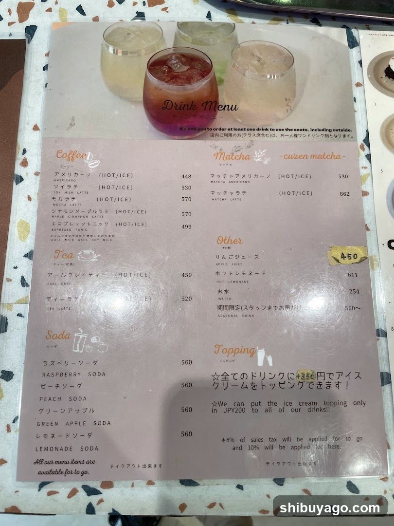 A printed drink menu featuring coffee, matcha, tea, soda, and topping options with prices in JPY.