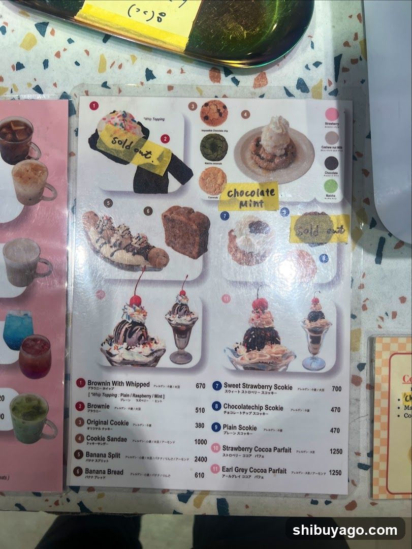 A printed menu page featuring various desserts including Brownies, Cookies, and Scones with prices listed in yen.