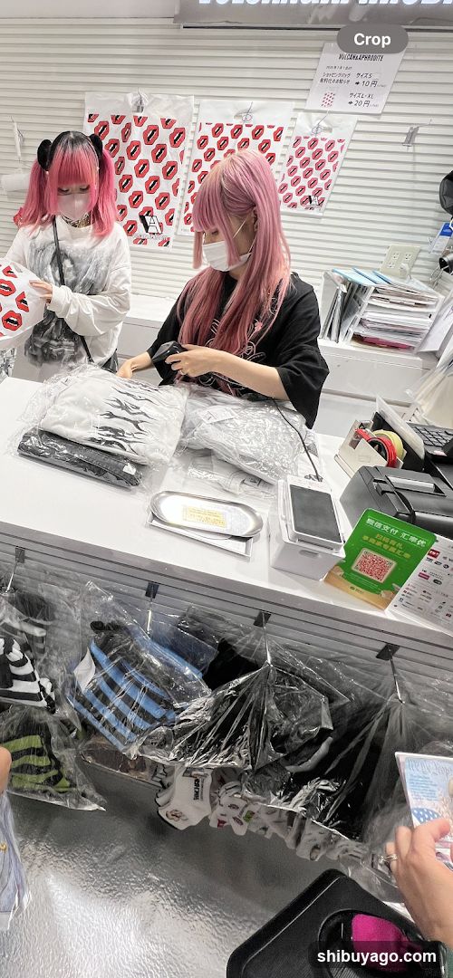 Store Interior with Pink-Haired Staff and Customer