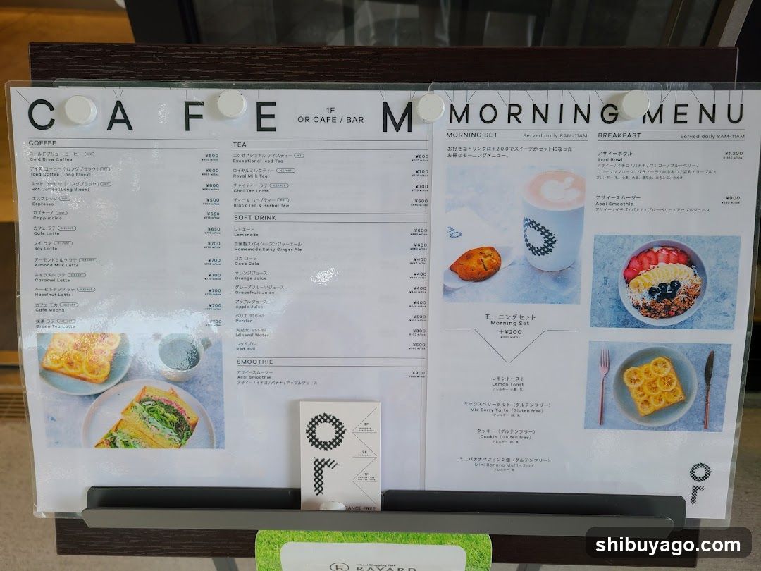 A printed menu board displaying coffee, tea, soft drinks, smoothies, and breakfast items with prices in yen.