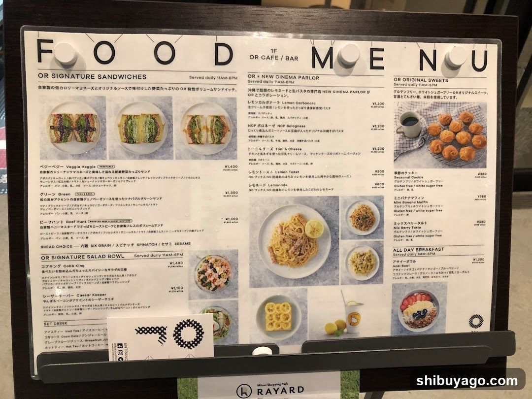 A menu board displaying food and drink options, including signature sandwiches, salads, and sweets.