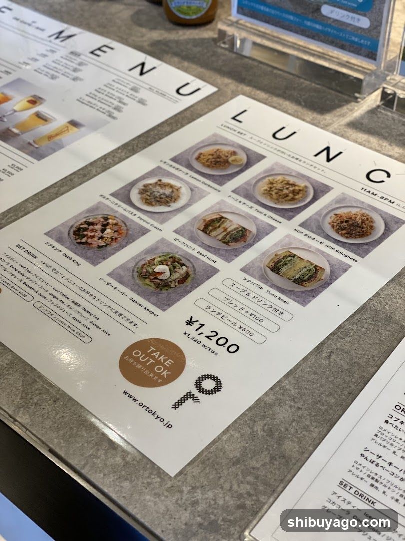A printed lunch menu on a table, featuring images and descriptions of various dishes with prices in yen.