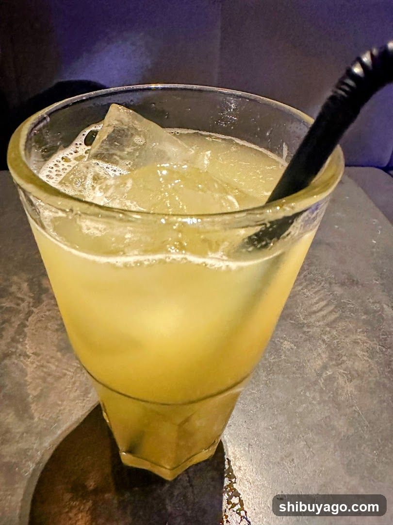 Yellow Iced Drink with Black Straw
