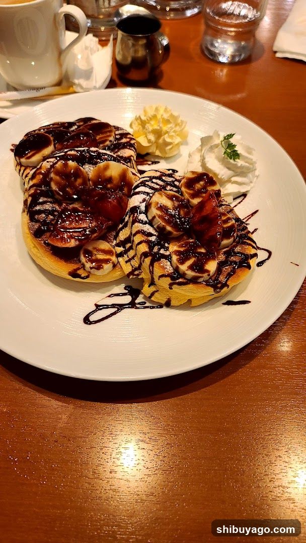 Banana Pancakes with Syrup and Whipped Cream