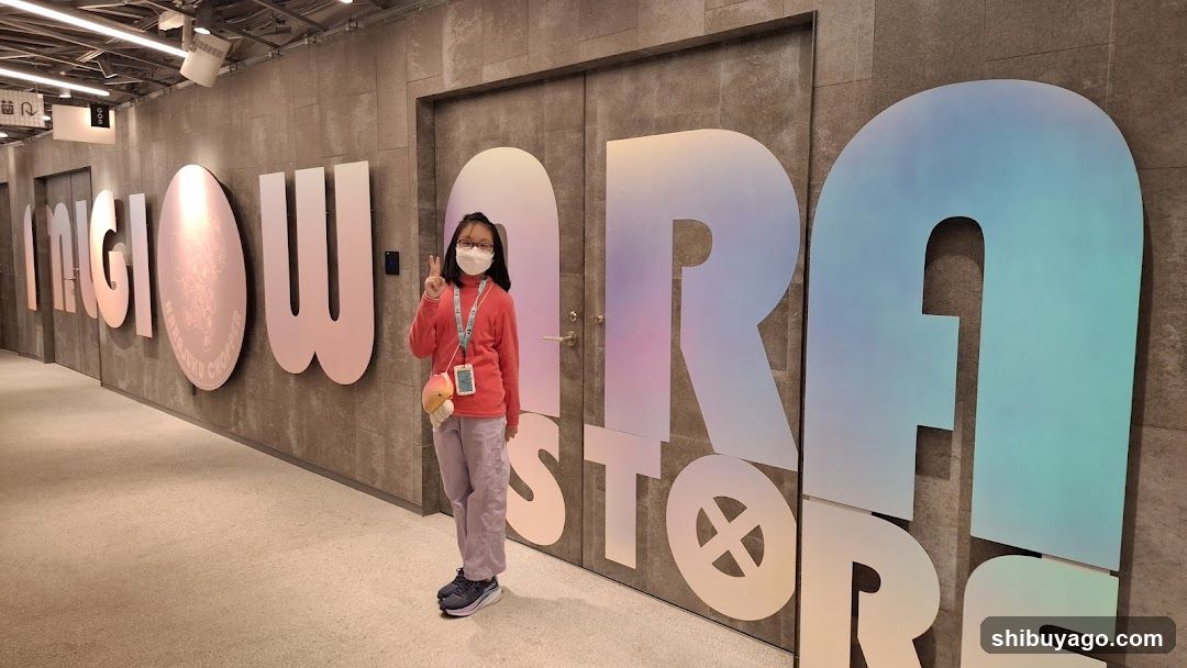 Person posing in front of large wall letters