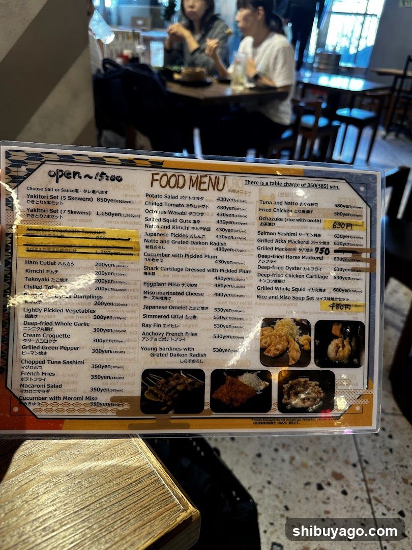A close-up of a laminated food menu board in a restaurant, featuring Japanese and English text with prices in yen.