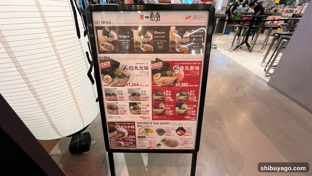 A vertical menu board displaying ramen set menus and individual toppings, with prices in JPY.