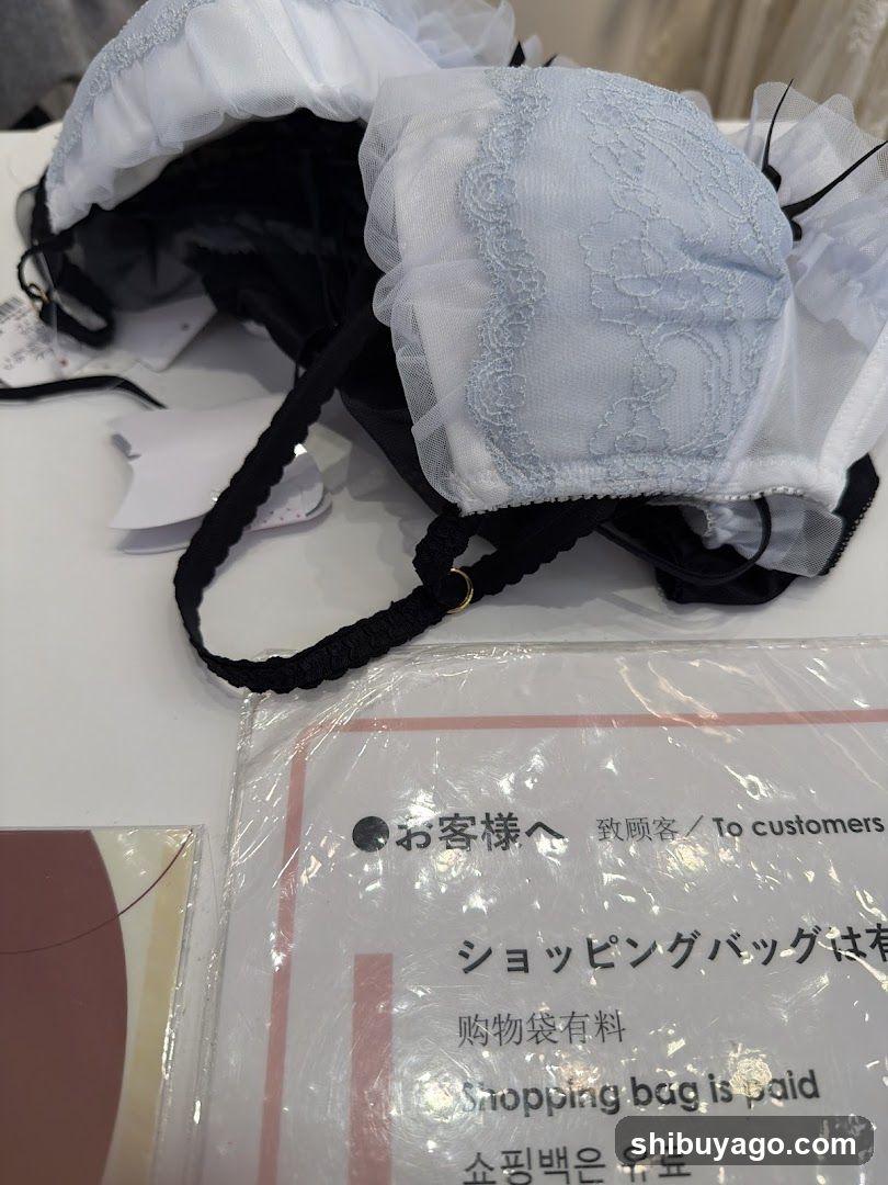 Bodysuit Display with Shopping Bag Notice